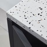 A close-up view of a Terrazzo White granite slab with a beautiful mix of white, gray, and black speckles